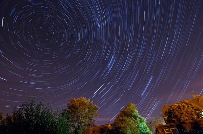 [UNVERIFIED CONTENT] Star trails over a light polluted Sutton Courtenay (a small village in Oxfordshire). A meteor from the Perseid meteor shower is visible.