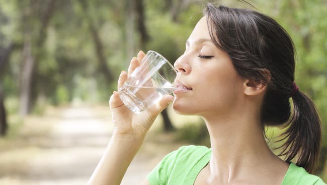 young woman drinking with waterglass