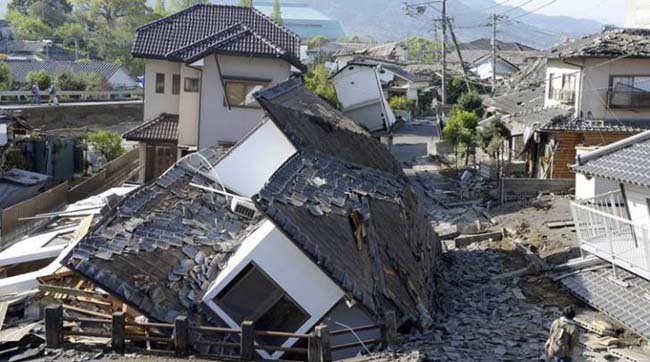 Houses are seen destroyed after an earthquake in Mashiki, Kumamoto prefecture, southern Japan Saturday, April 16, 2016. A powerful earthquake struck southern Japan early Saturday, barely 24 hours after a smaller quake hit the same region. (Ryosuke Uematsu/Kyodo News via AP) JAPAN OUT, MANDATORY CREDIT