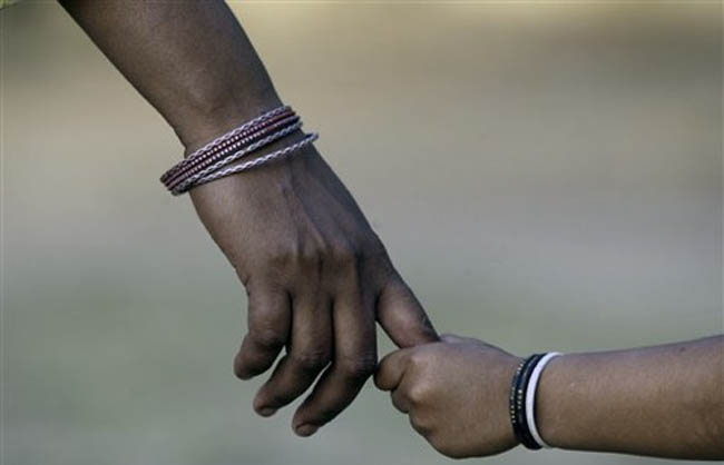 An Indian woman's hand seen as she walks with her child ahead of Mother's Day, in Allahabad, India, Thursday, May 7, 2009. Mother's Day will be celebrated on Sunday, May 10. (AP Photo/Rajesh Kumar Singh)